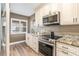 Updated kitchen featuring granite countertops and stainless steel appliances at 8210 Aquila St # 223, Port Richey, FL 34668
