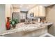 Modern kitchen with granite countertops and stainless steel appliances at 8210 Aquila St # 223, Port Richey, FL 34668