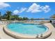 Community pool with lounge chairs and waterfront views at 8210 Aquila St # 223, Port Richey, FL 34668