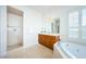 Spa-like bathroom with soaking tub, shower, and wood cabinets at 1500 Ember Ln, Tarpon Springs, FL 34689