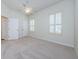 Bright bedroom with plush carpeting and window shutters at 1500 Ember Ln, Tarpon Springs, FL 34689