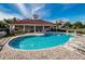 Relaxing kidney-shaped pool with a clubhouse and lounge chairs at 1500 Ember Ln, Tarpon Springs, FL 34689