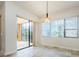 Bright dining area with sliding glass doors leading to a balcony at 1500 Ember Ln, Tarpon Springs, FL 34689