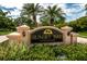 Sunset Bay Townhomes entrance sign with landscaping at 1500 Ember Ln, Tarpon Springs, FL 34689