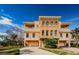 Attractive three-story home with two-car garage and manicured lawn at 1500 Ember Ln, Tarpon Springs, FL 34689