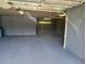 Unfinished garage with high ceilings and extra storage at 1500 Ember Ln, Tarpon Springs, FL 34689