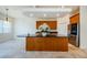 Island kitchen with granite countertops and wood cabinets at 1500 Ember Ln, Tarpon Springs, FL 34689