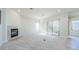 Spacious living room with fireplace and sliding glass doors at 1500 Ember Ln, Tarpon Springs, FL 34689