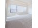 Bright main bedroom with large window and neutral decor at 1500 Ember Ln, Tarpon Springs, FL 34689