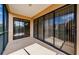 Spacious screened balcony with sliding glass doors and views of the community at 1500 Ember Ln, Tarpon Springs, FL 34689