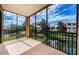 Private screened balcony overlooking a tranquil pond and community at 1500 Ember Ln, Tarpon Springs, FL 34689