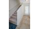 Interior staircase with neutral carpeting and tile flooring at 1500 Ember Ln, Tarpon Springs, FL 34689