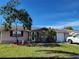 Ranch style home with carport and mature landscaping at 1153 Tamarac Dr, Holiday, FL 34690