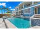 The stunning backyard boasts a pool, stylish seating areas, and breathtaking waterfront views at 295 Bayside Dr, Clearwater Beach, FL 33767