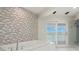 Bathroom with tub, shower and a sliding glass door with water views at 295 Bayside Dr, Clearwater Beach, FL 33767