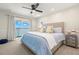 Bedroom with sliding doors, water view, neutral paint and coastal decor at 295 Bayside Dr, Clearwater Beach, FL 33767