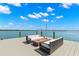 Dockside seating area with a fire pit, perfect for enjoying waterfront views and relaxing outdoors at 295 Bayside Dr, Clearwater Beach, FL 33767