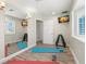 Brightly lit exercise room with wall mirror, weight rack and mounted tv at 295 Bayside Dr, Clearwater Beach, FL 33767