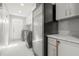 Well lit Laundry room with modern appliances, marble countertop and white cabinets at 295 Bayside Dr, Clearwater Beach, FL 33767