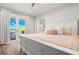 Bright main bedroom featuring white wood floors, a large bed, and sliding glass doors to the outside patio at 295 Bayside Dr, Clearwater Beach, FL 33767