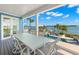 Inviting outdoor dining area with views of the pool and the waterfront at 295 Bayside Dr, Clearwater Beach, FL 33767