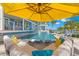 Lounge by the pool, featuring in-pool seating and waterfront views, covered by a yellow umbrella at 295 Bayside Dr, Clearwater Beach, FL 33767