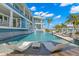 Relax in this stunning pool with integrated lounge chairs and beautiful backyard waterfront views at 295 Bayside Dr, Clearwater Beach, FL 33767