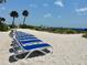 Blue and white lounge chairs neatly arranged on a sandy beach at 5500 Gulf Blvd # 7211, St Pete Beach, FL 33706