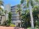 Multi-story building with tropical landscaping and palm trees at 5500 Gulf Blvd # 7211, St Pete Beach, FL 33706