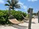 Two hammocks hanging on the beach near lush greenery at 5500 Gulf Blvd # 7211, St Pete Beach, FL 33706