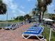 Row of blue lounge chairs overlooking the ocean on a brick patio at 5500 Gulf Blvd # 7211, St Pete Beach, FL 33706