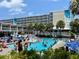 Large pool deck with many lounge chairs surrounding a refreshing pool at 5500 Gulf Blvd # 7211, St Pete Beach, FL 33706