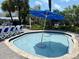 Relaxing resort pool with a blue umbrella at 5500 Gulf Blvd # 7211, St Pete Beach, FL 33706