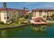 Condo complex featuring a pool, dock, and waterfront access at 105 Island Way # 121, Clearwater Beach, FL 33767