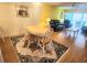 Bright dining area with wood floors and a table for four at 105 Island Way # 121, Clearwater Beach, FL 33767