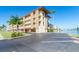 Exterior view of condo building showcasing parking and waterfront access at 105 Island Way # 121, Clearwater Beach, FL 33767