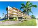 Exterior view of The Islander condo building, featuring palm trees at 105 Island Way # 121, Clearwater Beach, FL 33767