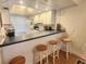 Kitchen with white cabinets, breakfast bar, and hardwood floors at 105 Island Way # 121, Clearwater Beach, FL 33767