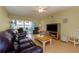 Bright living room with hardwood floors, leather sofas, and TV at 105 Island Way # 121, Clearwater Beach, FL 33767