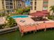 Resort-style pool, dock, and patio furniture at waterfront community at 105 Island Way # 121, Clearwater Beach, FL 33767