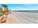 Relaxing beach scene with benches, white sand, and tranquil waterfront views at 855 Bayway Blvd # 101, Clearwater, FL 33767