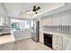 Well-lit kitchen with stainless steel appliances, white cabinets, and decorative backsplash, with a view to the dining area at 855 Bayway Blvd # 101, Clearwater, FL 33767