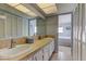 Bathroom with double sinks, tile countertops and large storage with white shutter doors that leads to the bedroom at 403 Gulf Way # 504, St Pete Beach, FL 33706