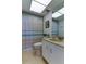 Cozy bathroom with shower, tub, white vanity, and blue striped shower curtain at 403 Gulf Way # 504, St Pete Beach, FL 33706