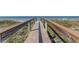 A beach access boardwalk offering an inviting path to a pristine sandy beach and ocean at 403 Gulf Way # 504, St Pete Beach, FL 33706