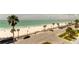 Expansive beach view showcasing white sand, clear water, palm trees, and a sunny sky near the property at 403 Gulf Way # 504, St Pete Beach, FL 33706