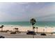 Stunning view overlooking a pristine beach with palm trees and clear turquoise water at 403 Gulf Way # 504, St Pete Beach, FL 33706