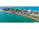 Beachfront community displaying colorful homes, a calm ocean, and a scenic coastal road at 403 Gulf Way # 504, St Pete Beach, FL 33706