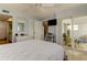 Spacious bedroom with tile flooring, ceiling fan, closet, and sliding door access to a balcony with outdoor seating at 403 Gulf Way # 504, St Pete Beach, FL 33706