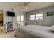 Relaxing bedroom featuring tile flooring, balcony access, a ceiling fan, and a serene, light blue color scheme at 403 Gulf Way # 504, St Pete Beach, FL 33706